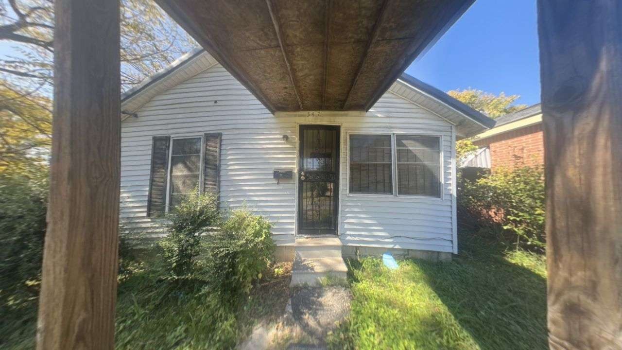 a view of house with backyard