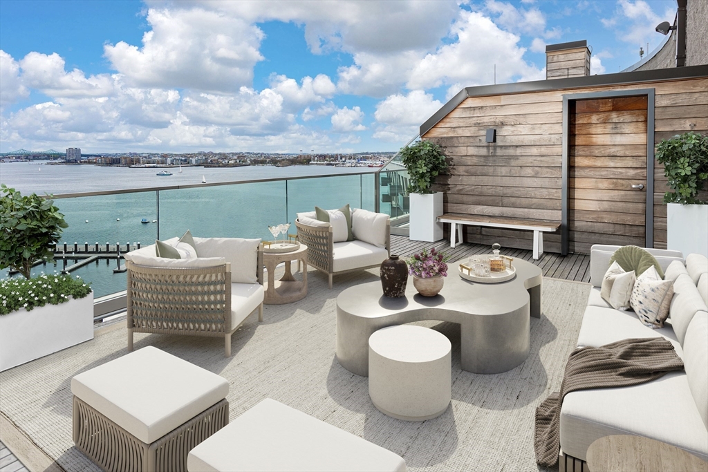 a balcony with furniture and a floor to ceiling window