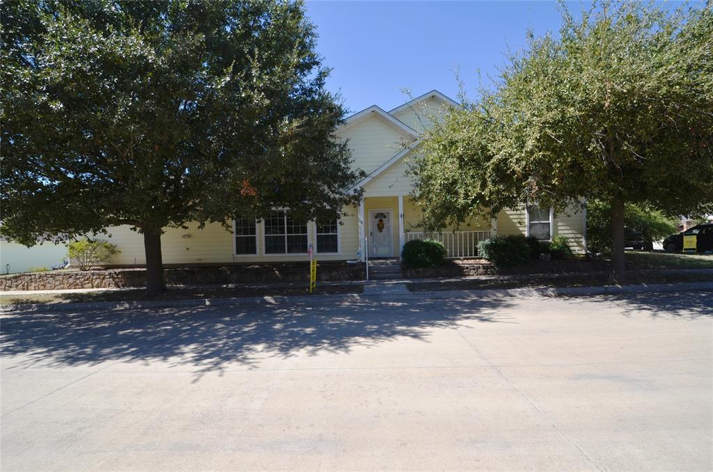 a view of a house with a tree in the background