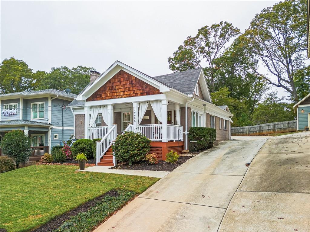 a front view of a house with a yard and potted plants