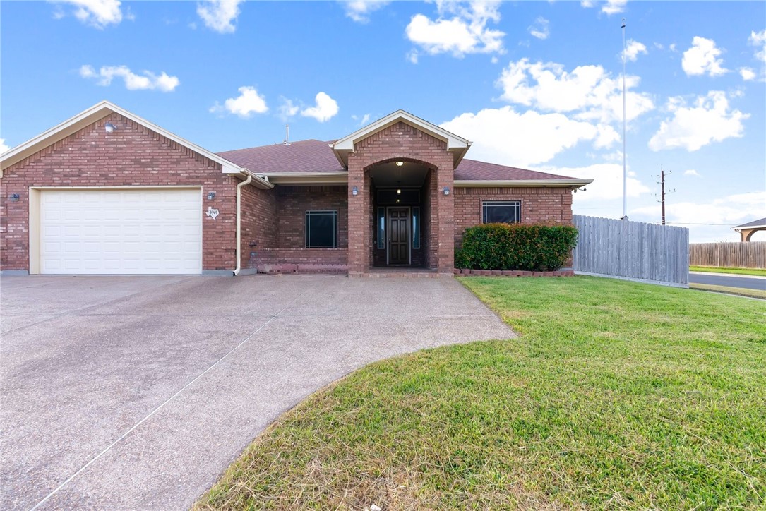 a view of a house with a yard and garage