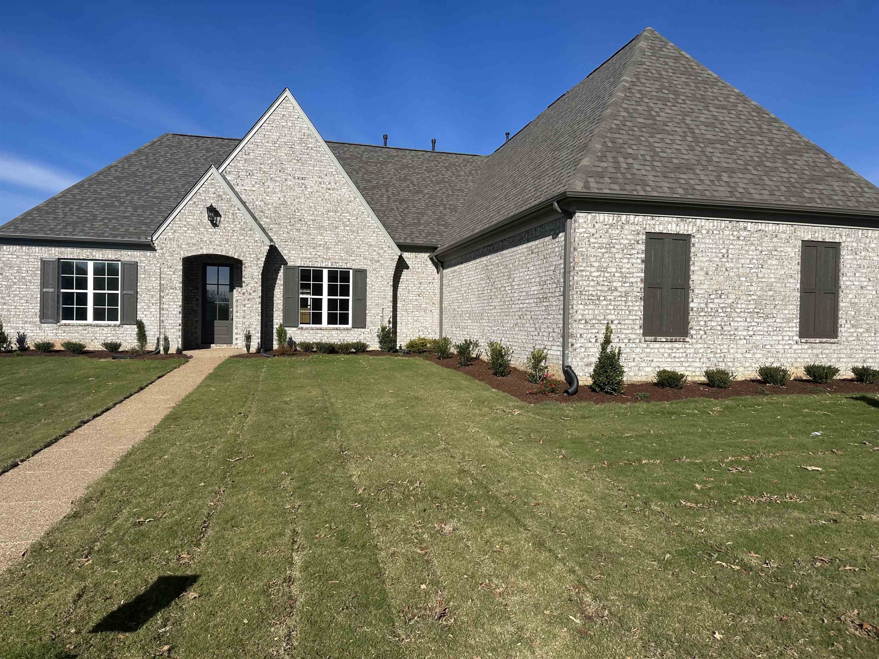 French country home featuring a front yard