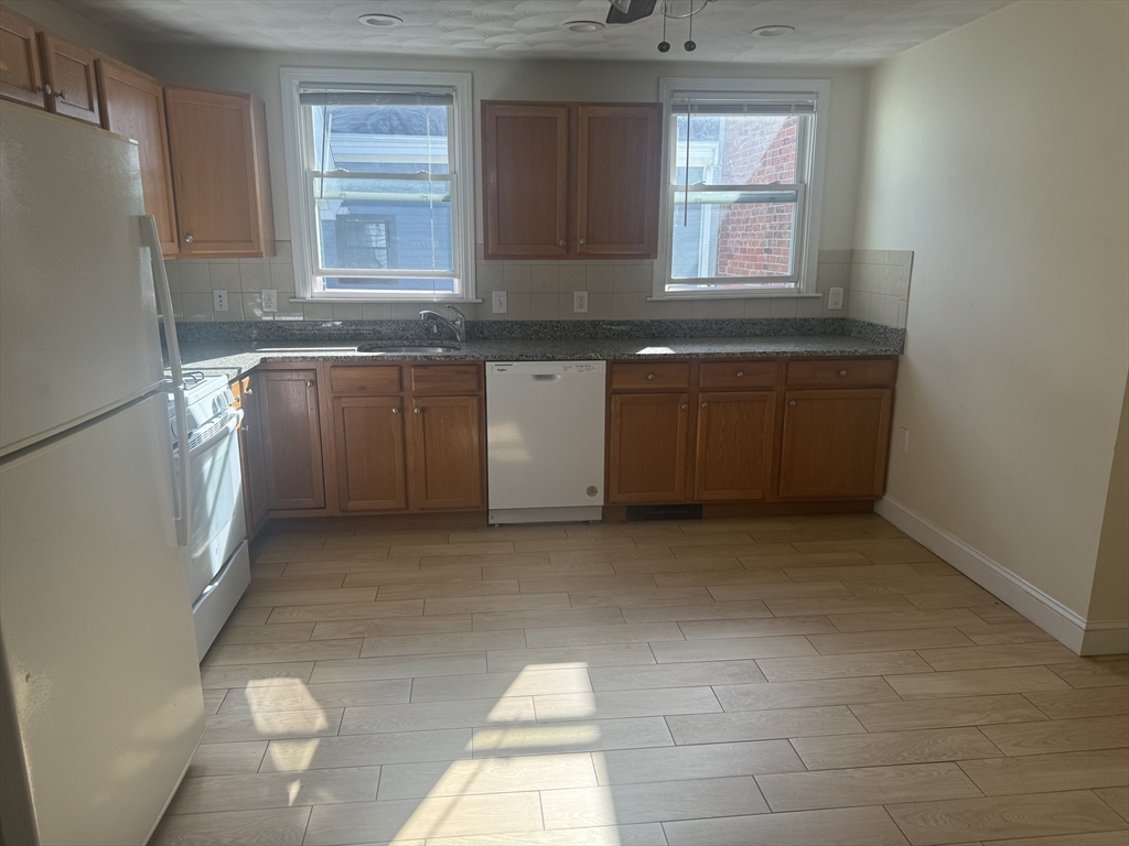 a kitchen with a stove a sink and a refrigerator