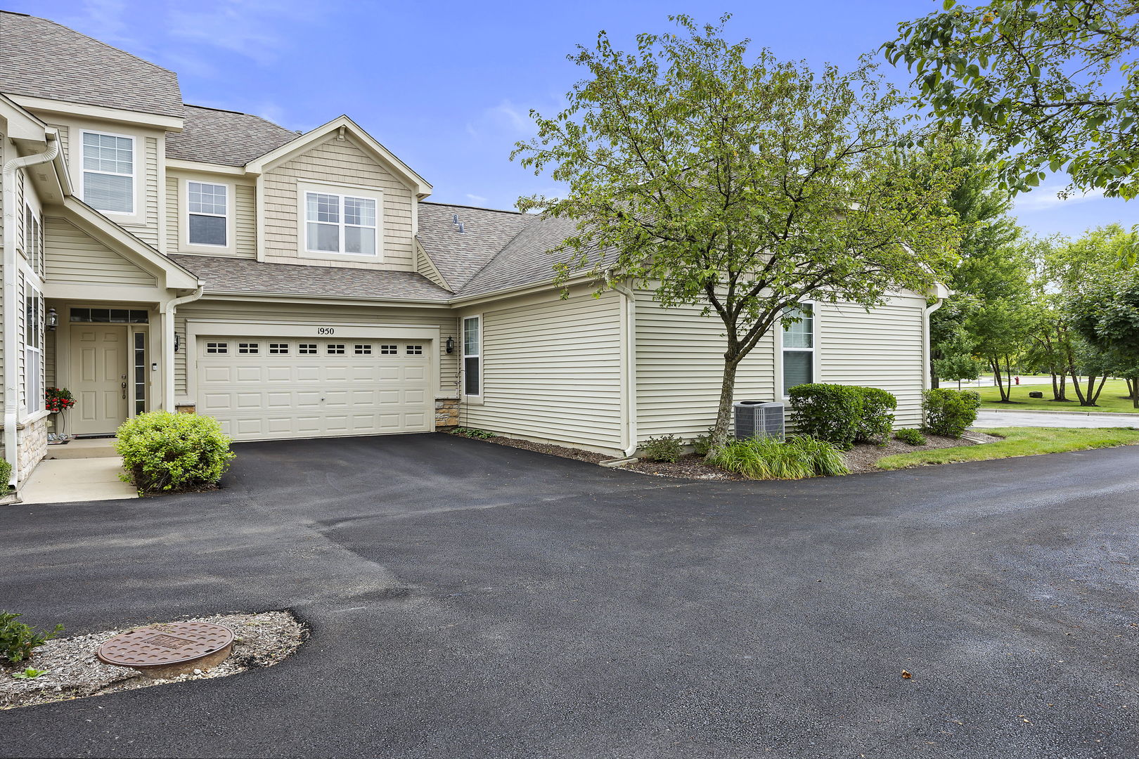 a view of a house with a yard and garage