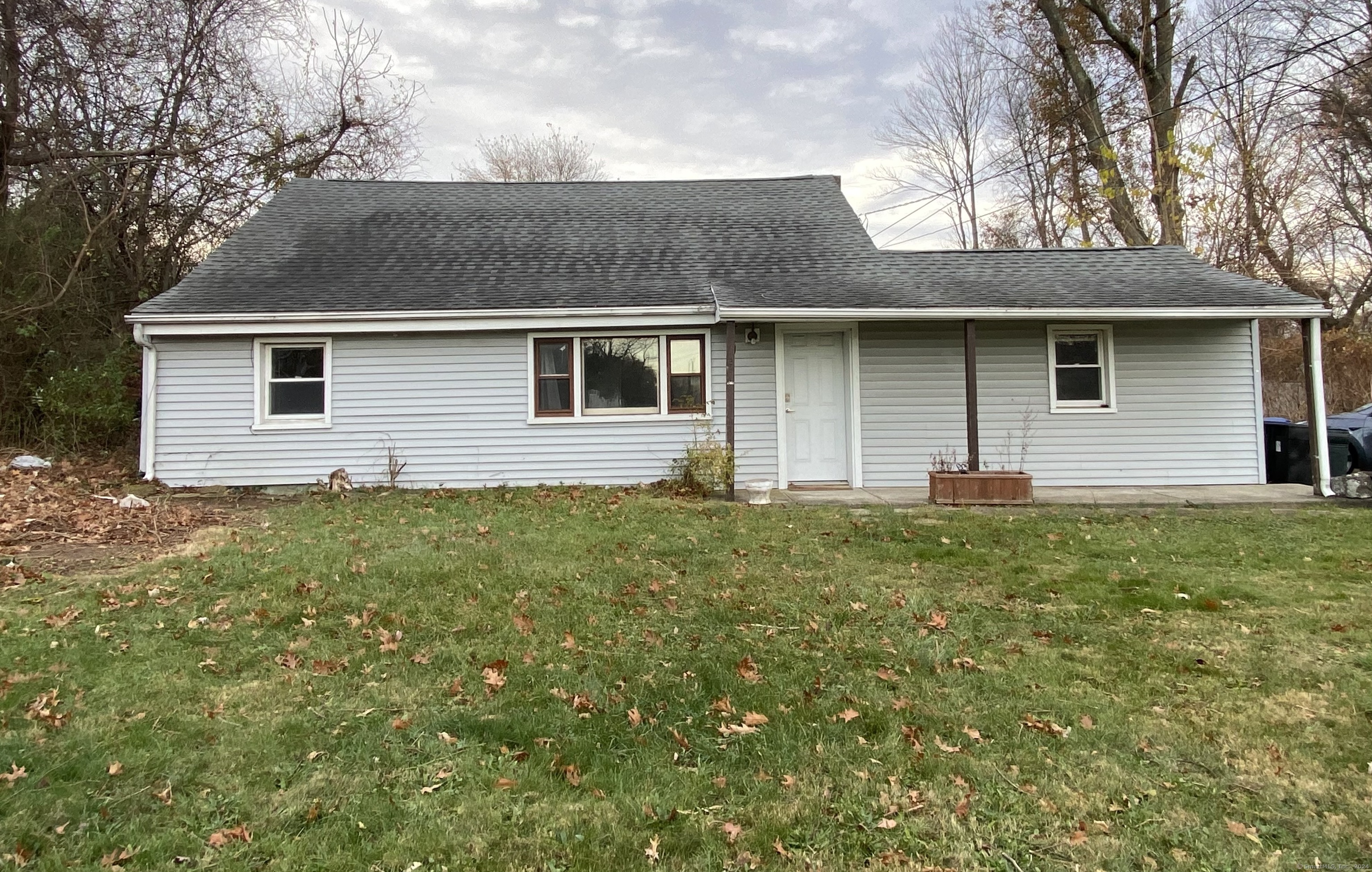 a front view of house with yard and trees