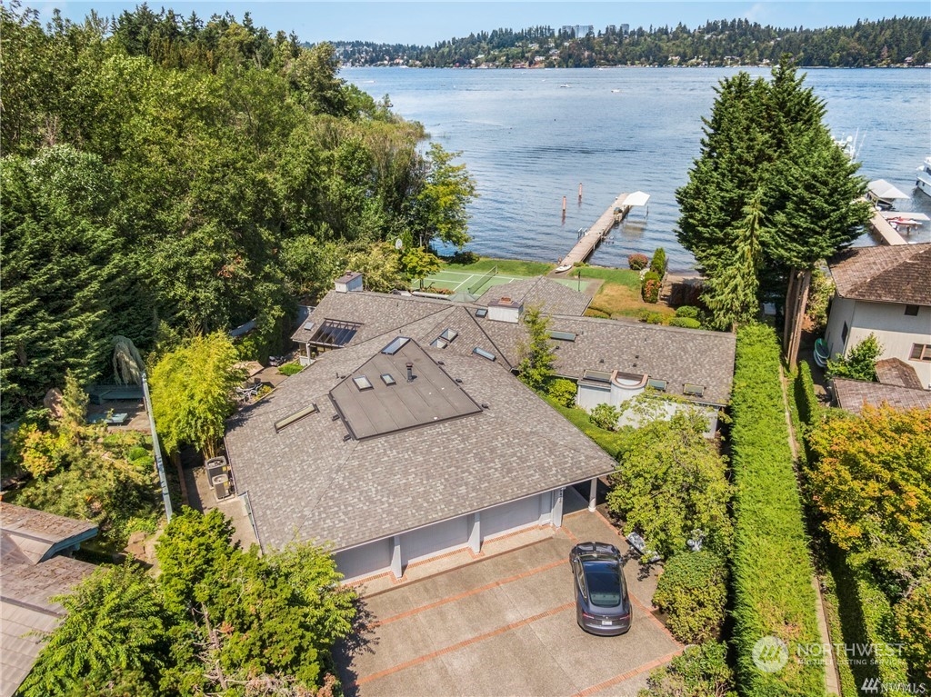 an aerial view of a house with outdoor space and lake view