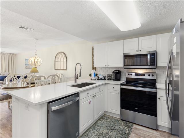 a kitchen with a sink stove and microwave