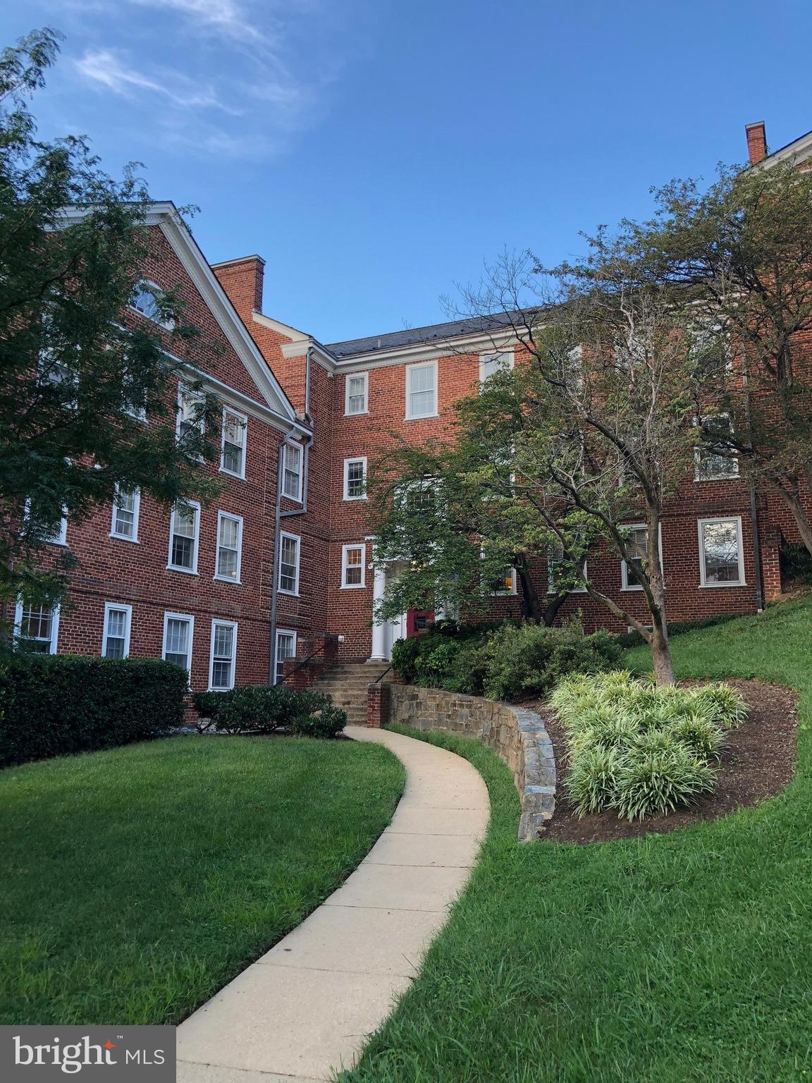 a view of a brick building next to a yard