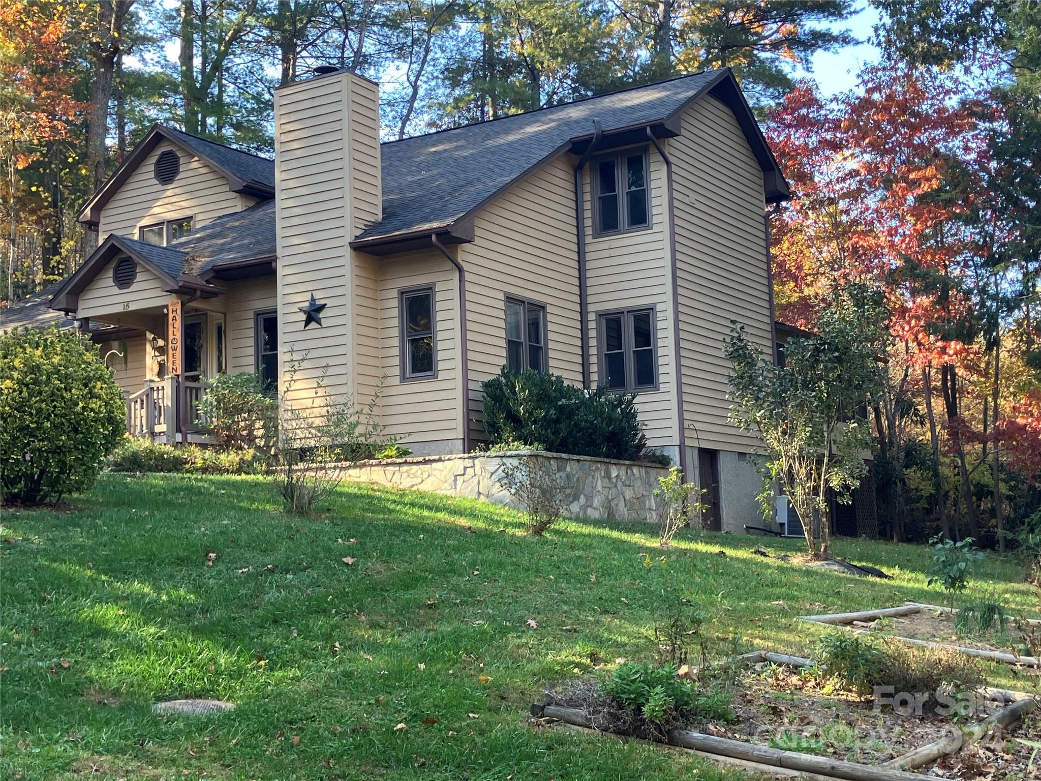 a front view of house with a garden