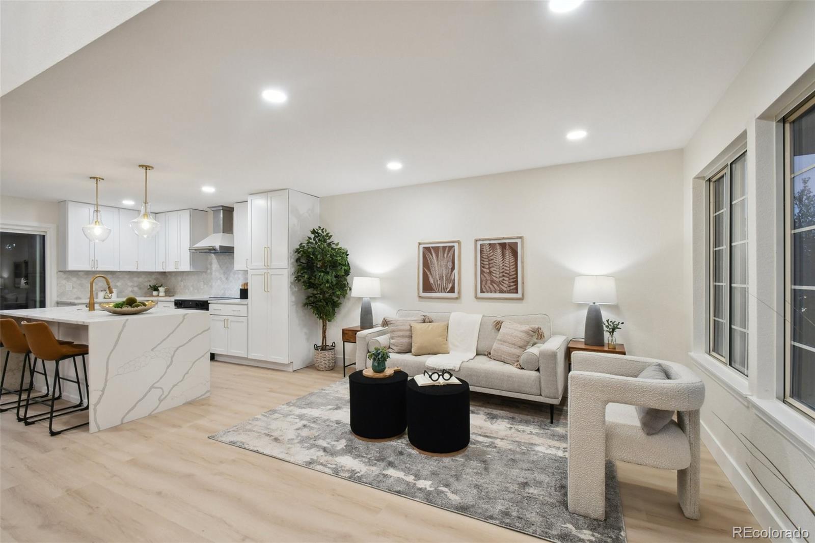 a living room with furniture and a potted plant