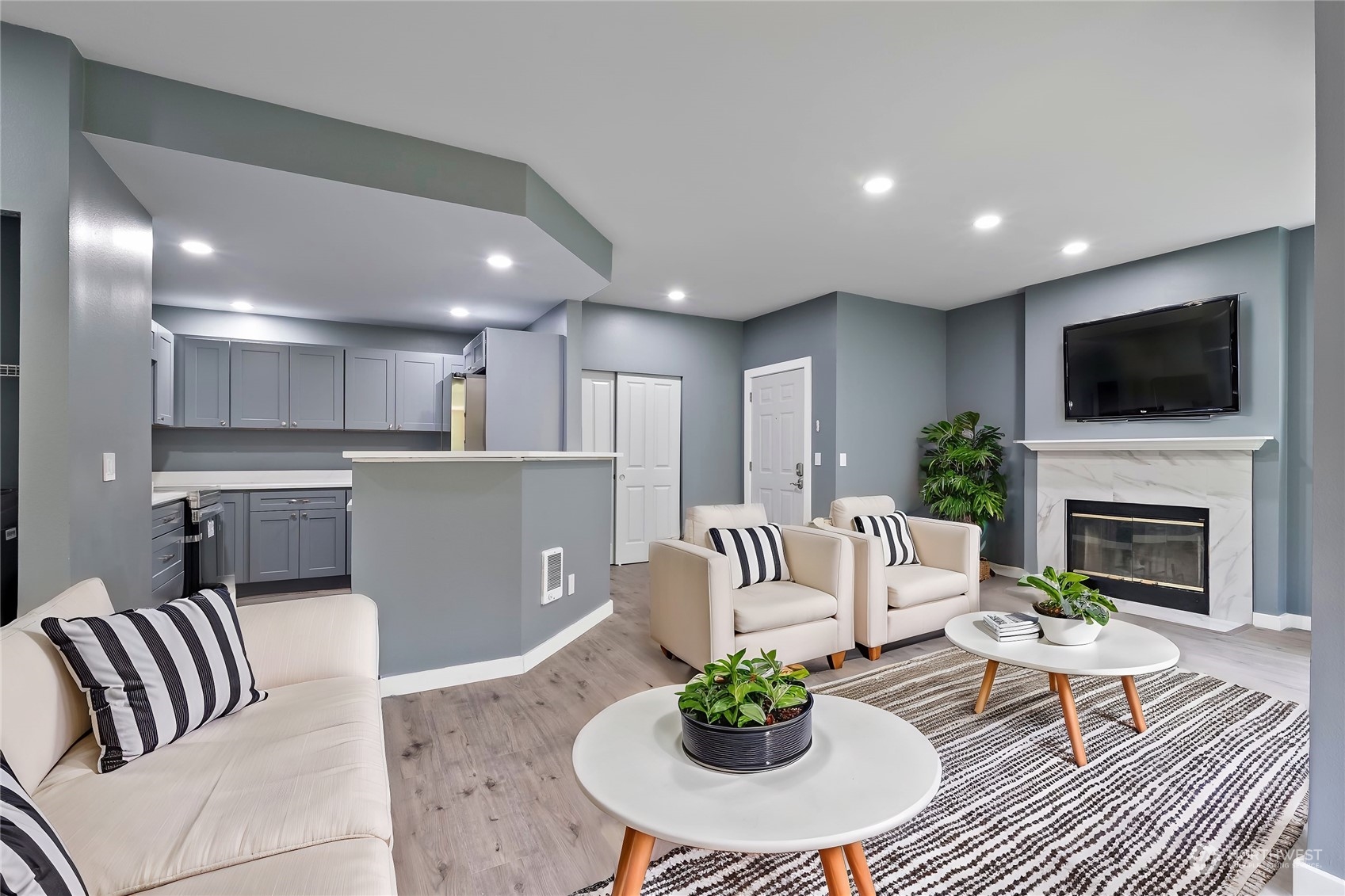 a living room with furniture a fireplace and a flat screen tv