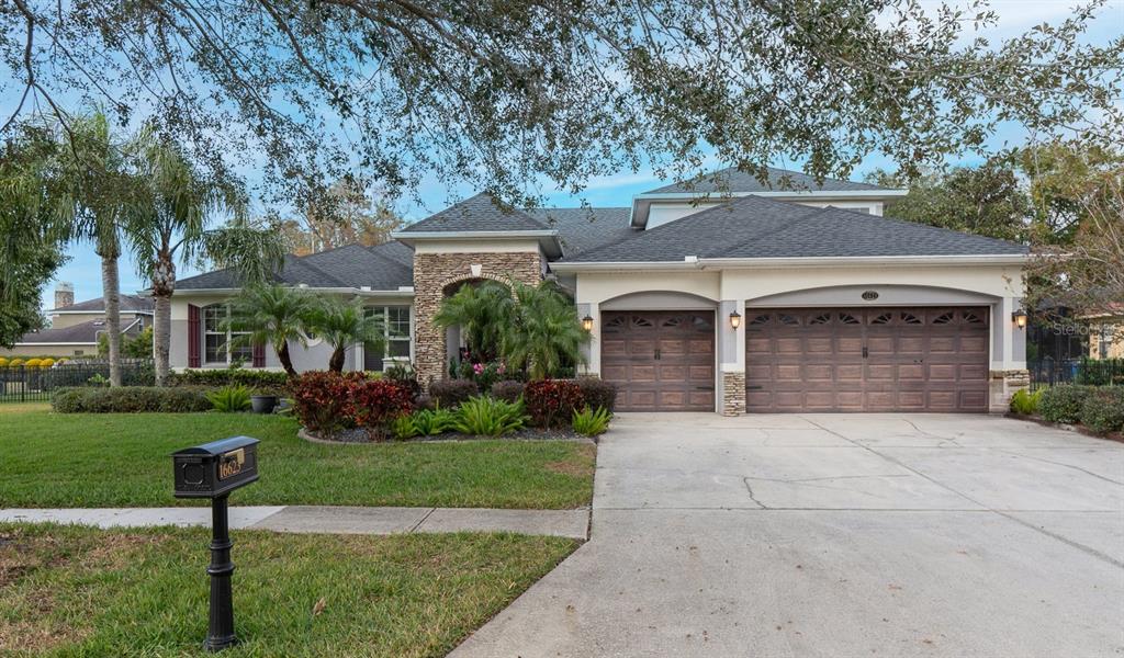 a front view of a house with a yard and garage