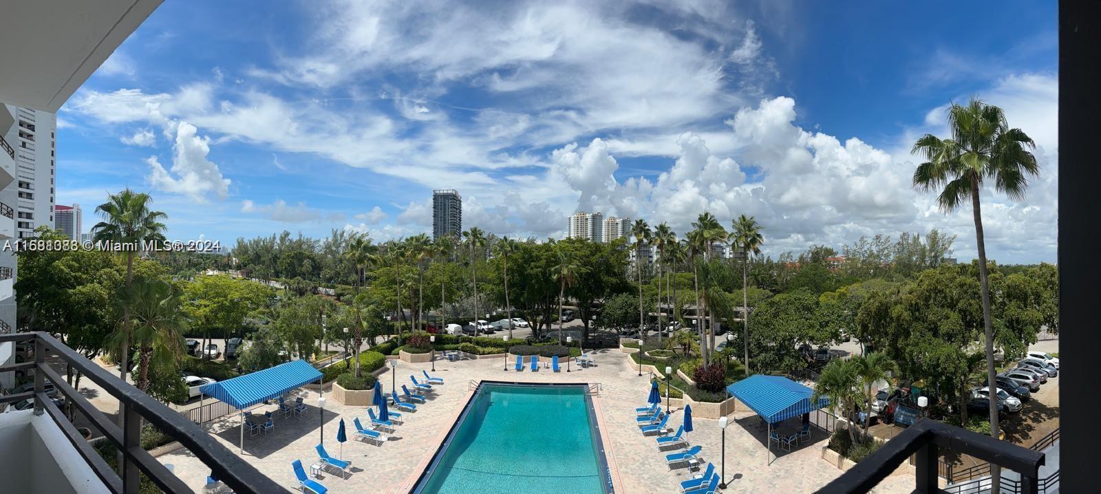 a view of a swimming pool with a patio and a yard