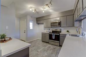 a kitchen with a sink and steel appliances