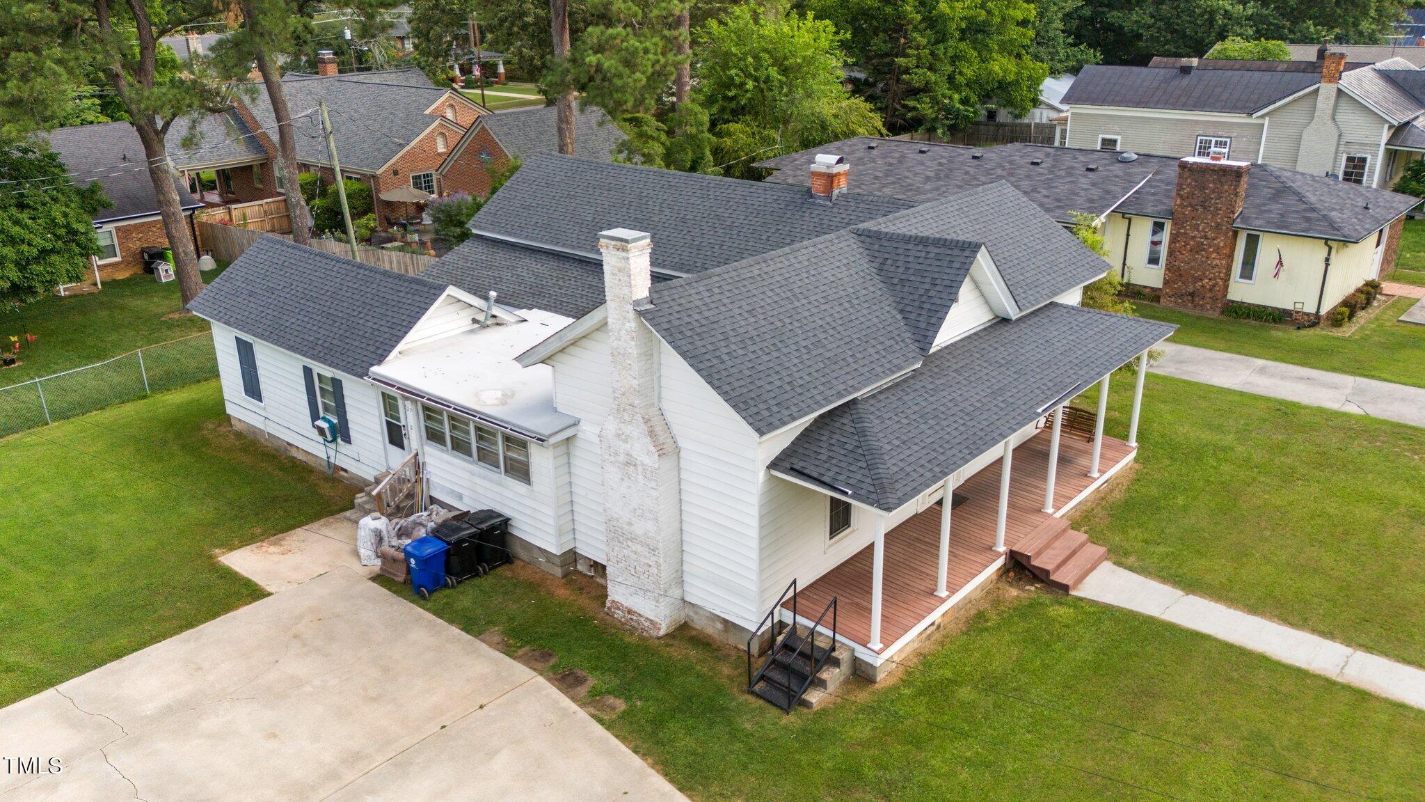 an aerial view of a house with a yard