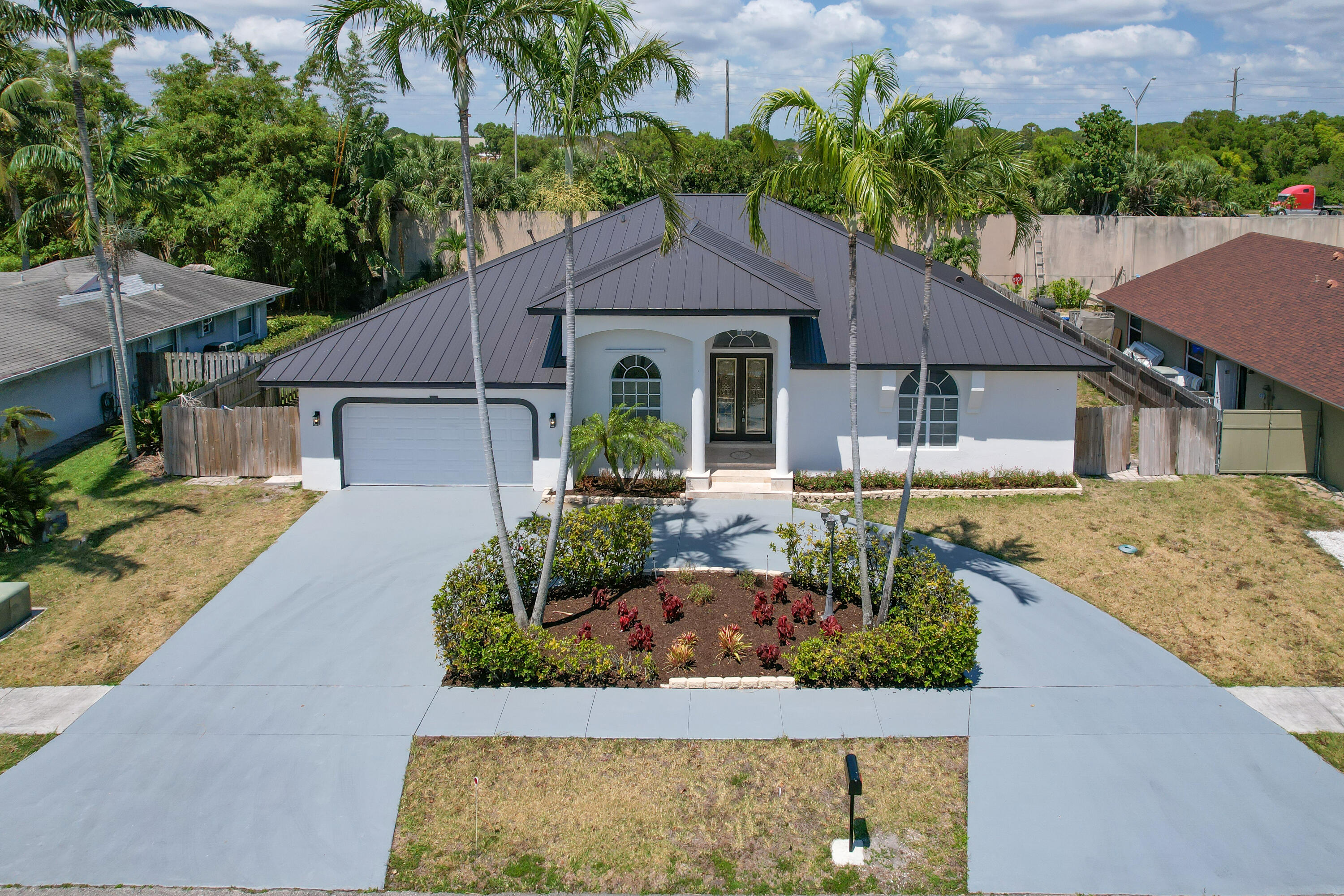 a front view of a house with a garden