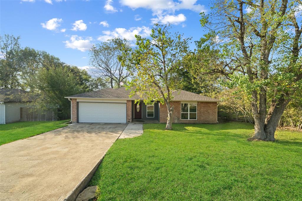 a front view of house with yard and trees