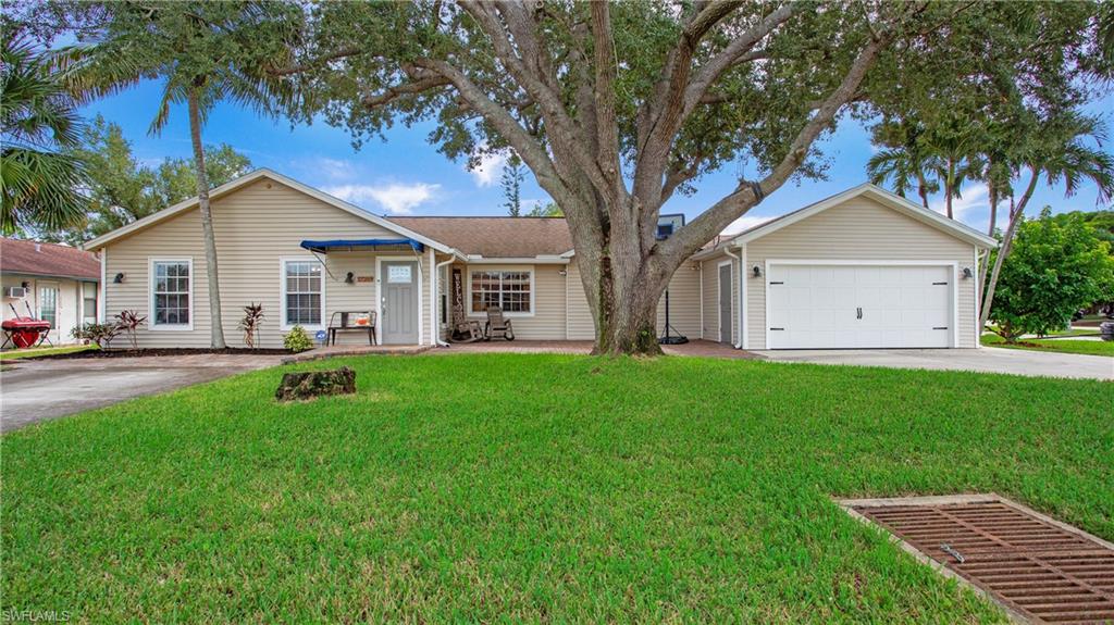 a view of a yard with a house and a tree