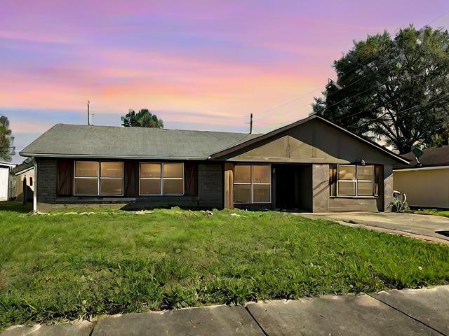 Ranch-style house featuring a yard