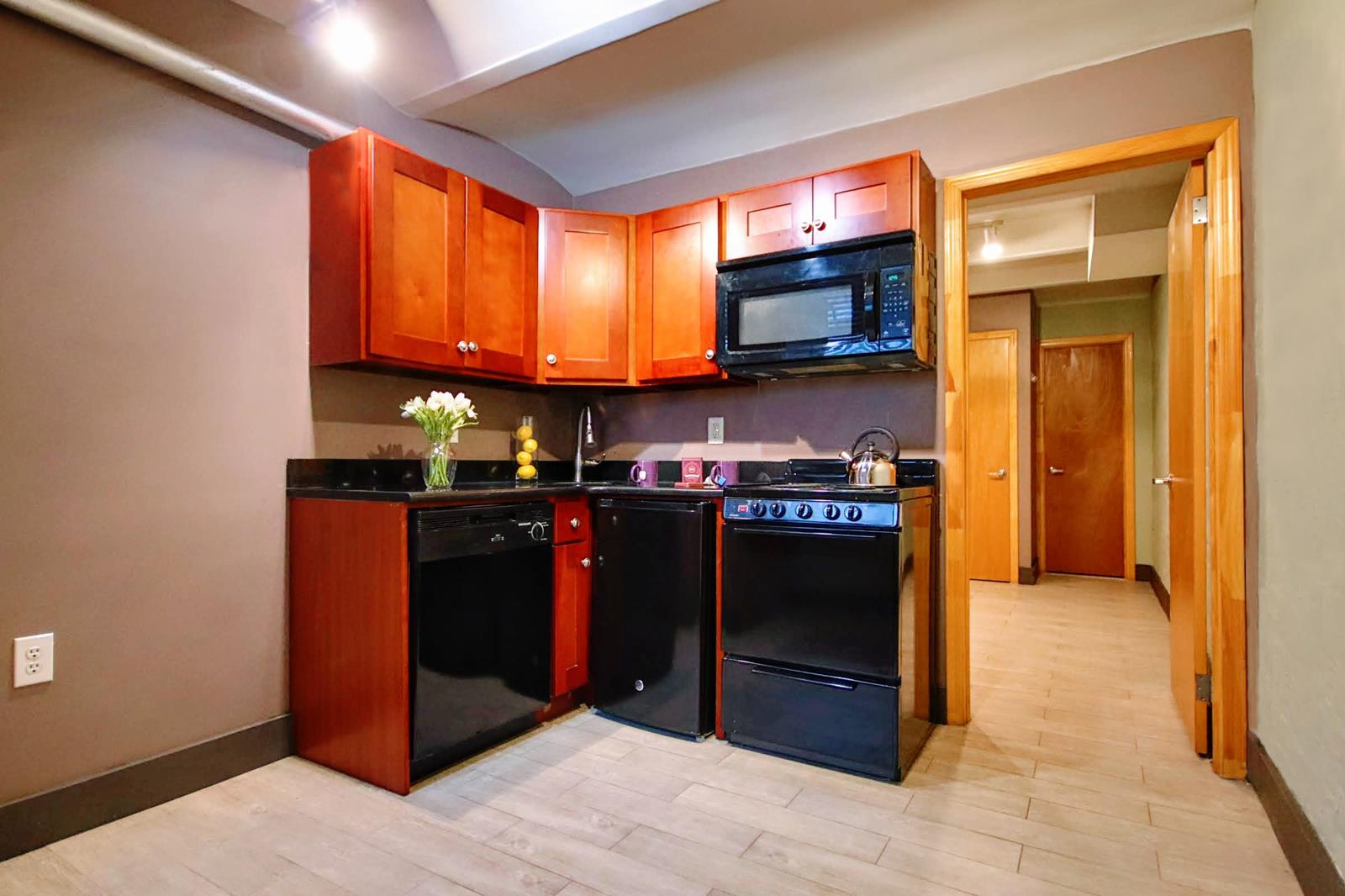 a kitchen with stainless steel appliances granite countertop a refrigerator and a sink