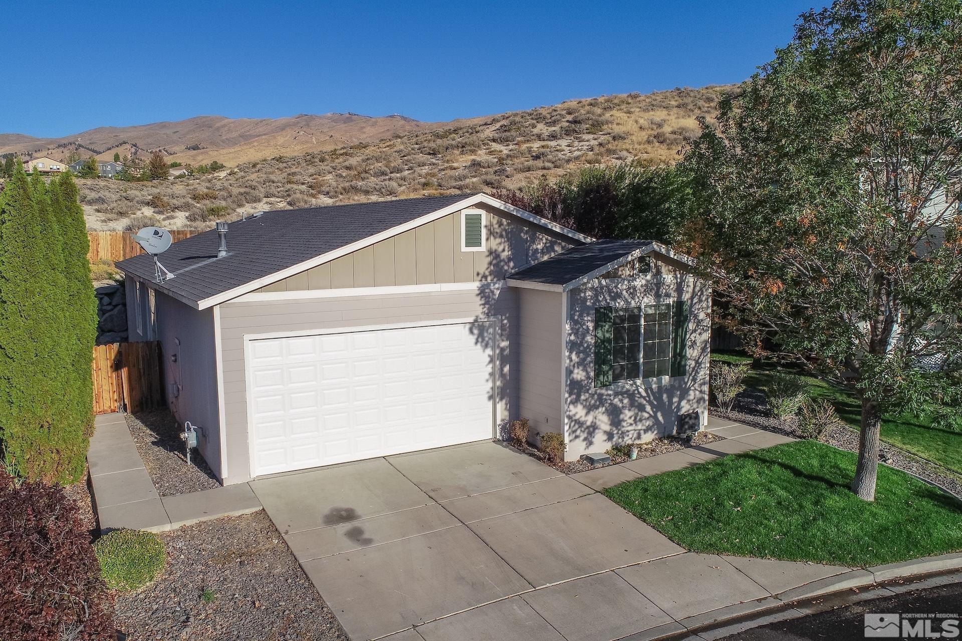 a front view of a house with mountain view