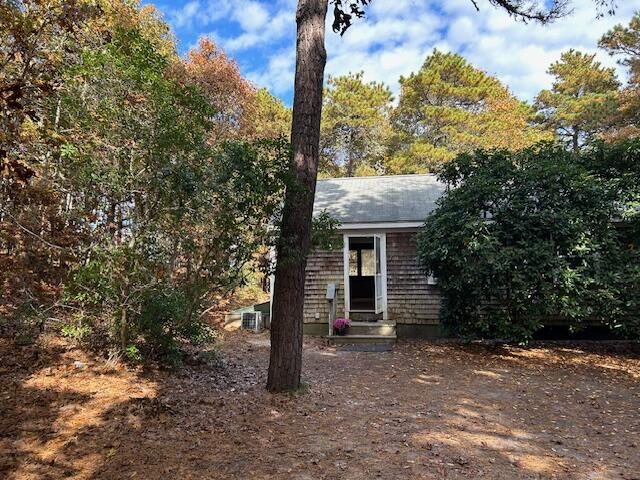 a front view of a house with a tree