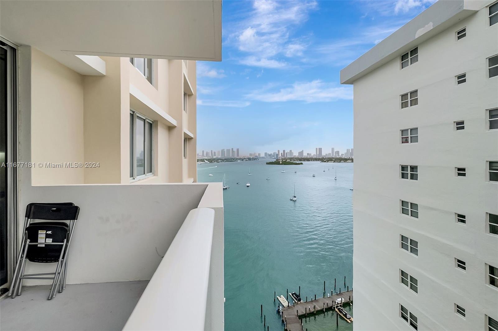 a view of a lake and a balcony with furniture