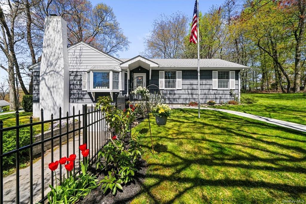 a front view of house with yard and green space