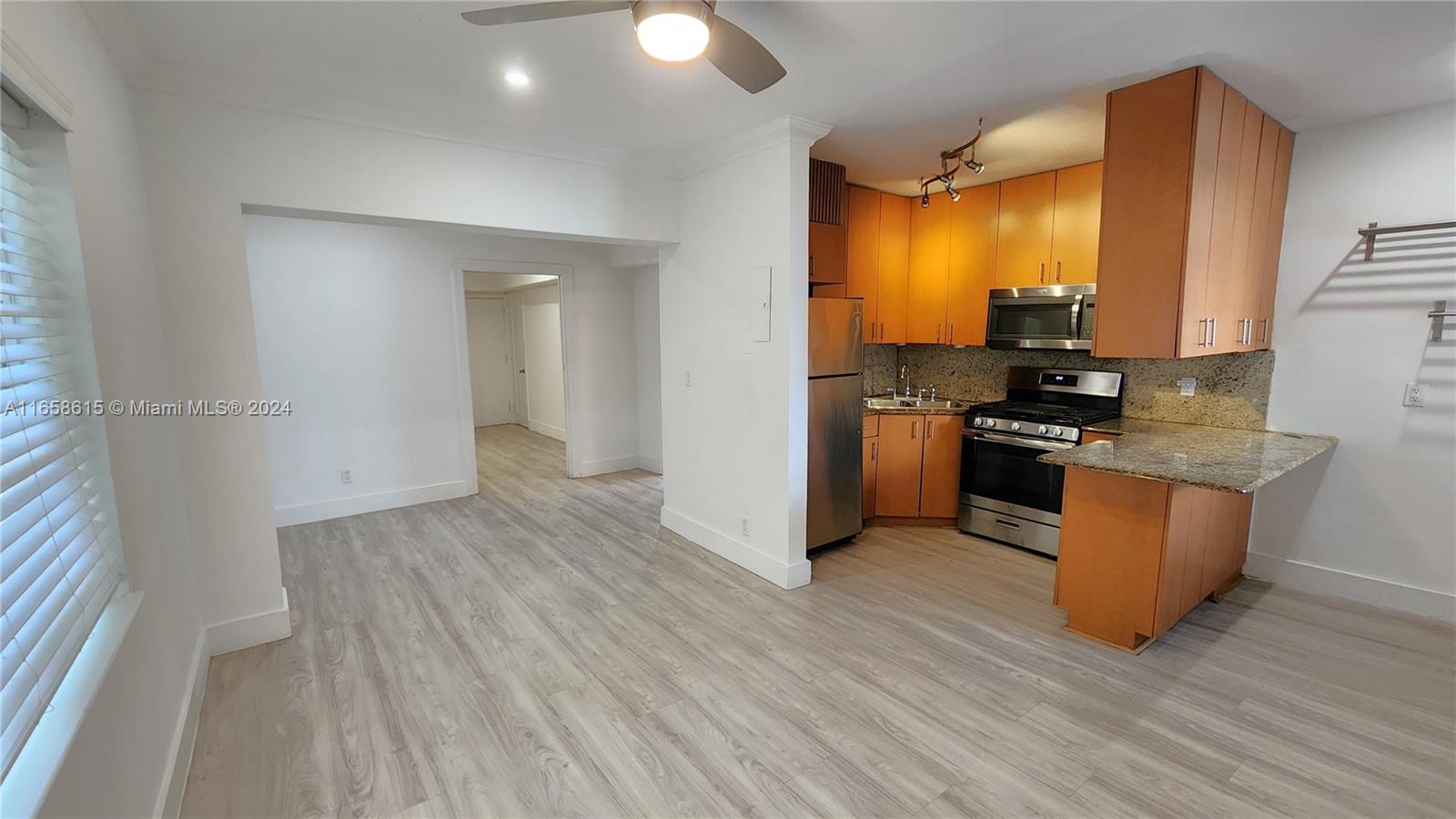 a kitchen with stainless steel appliances granite countertop a stove and a refrigerator