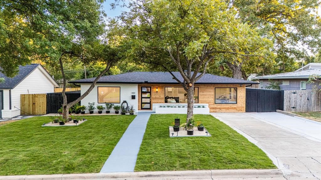 Gorgeous grass and wood accents on front of home!