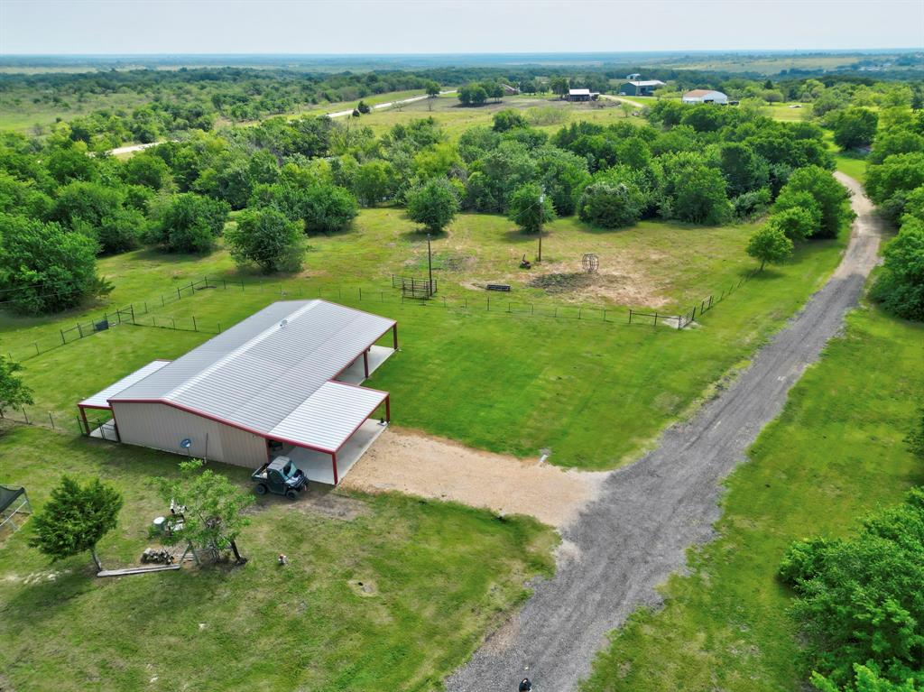 an aerial view of a house with yard