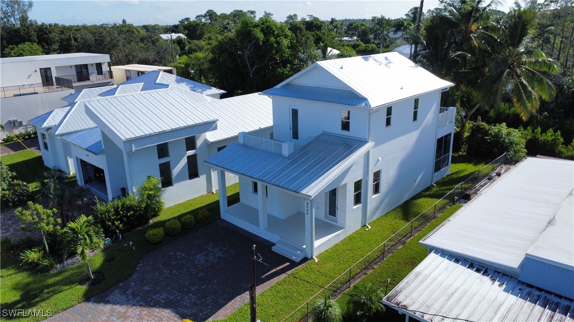 a aerial view of a house with a yard table and chairs