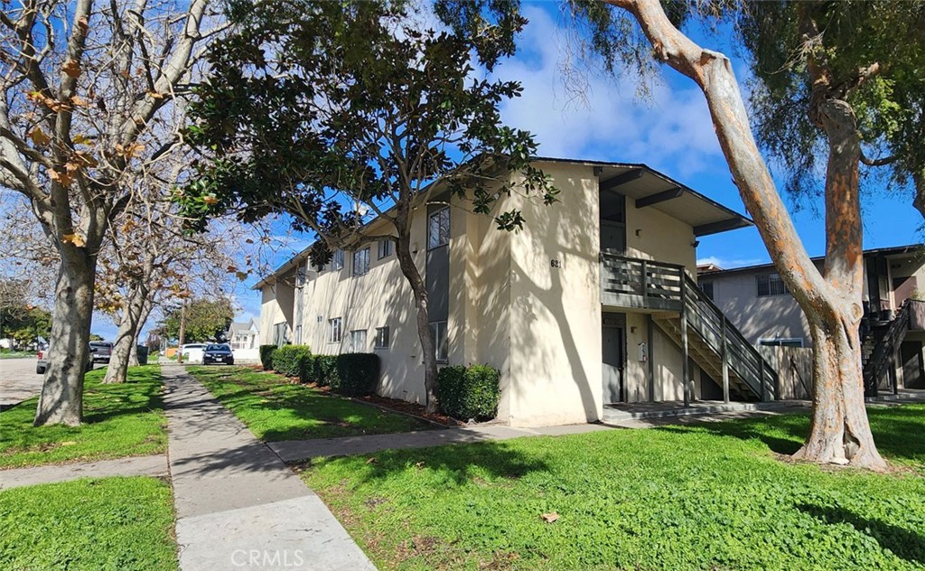 a front view of house with a garden