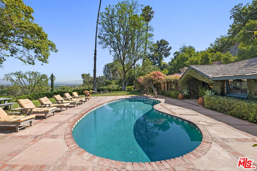 a view of a swimming pool with a yard