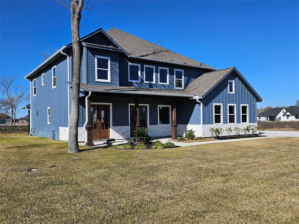 a front view of a house with a yard and porch