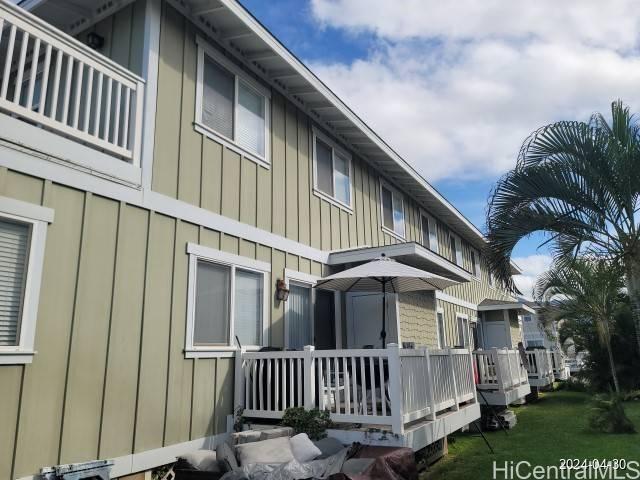 a view of a house with a yard and deck