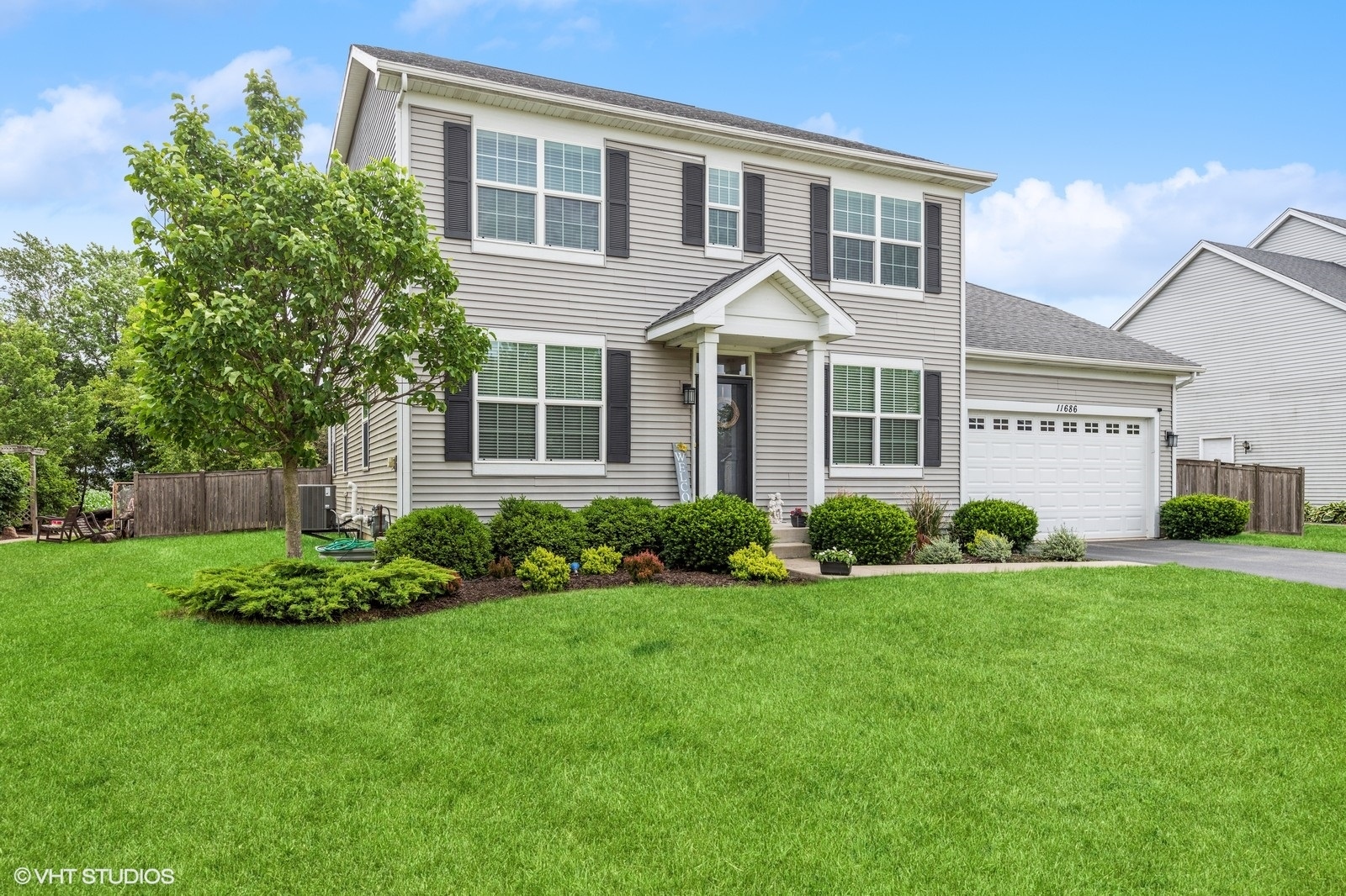 a front view of a house with a garden