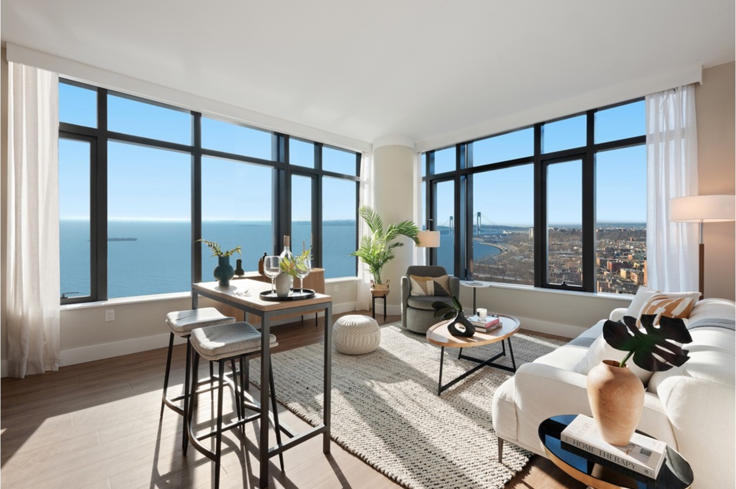 a living room with furniture and floor to ceiling windows