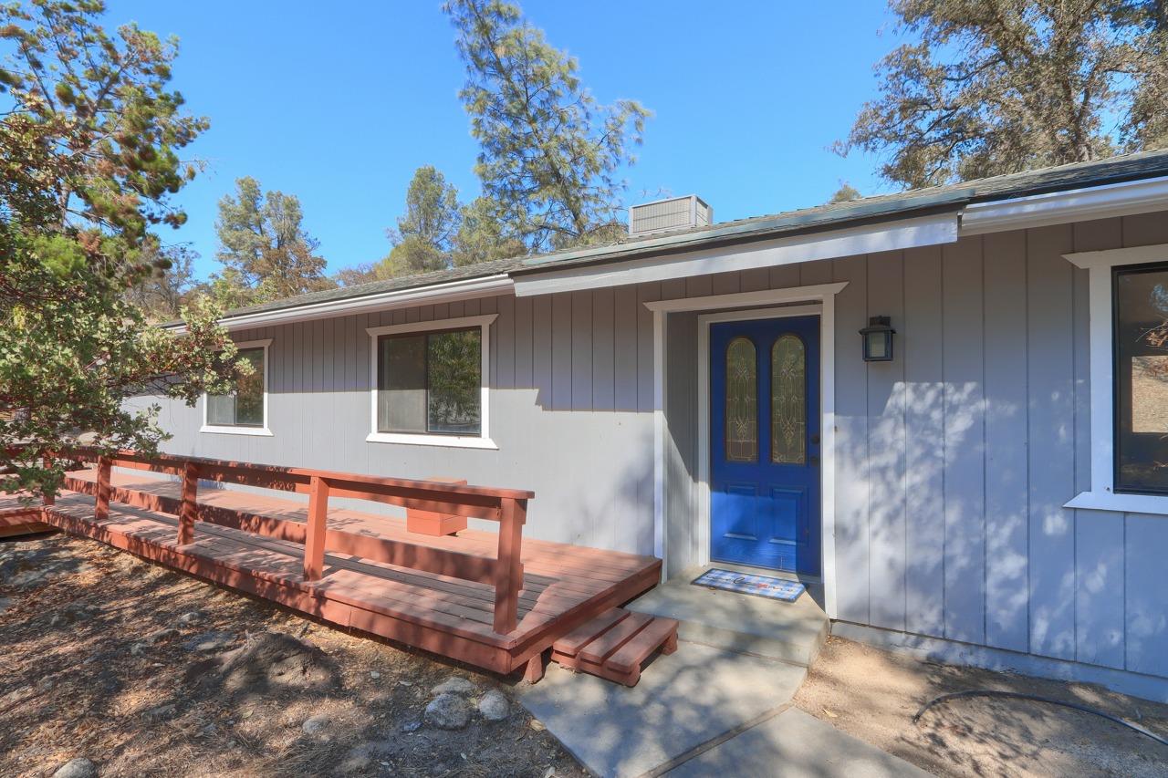 a view of house with roof and wooden fence