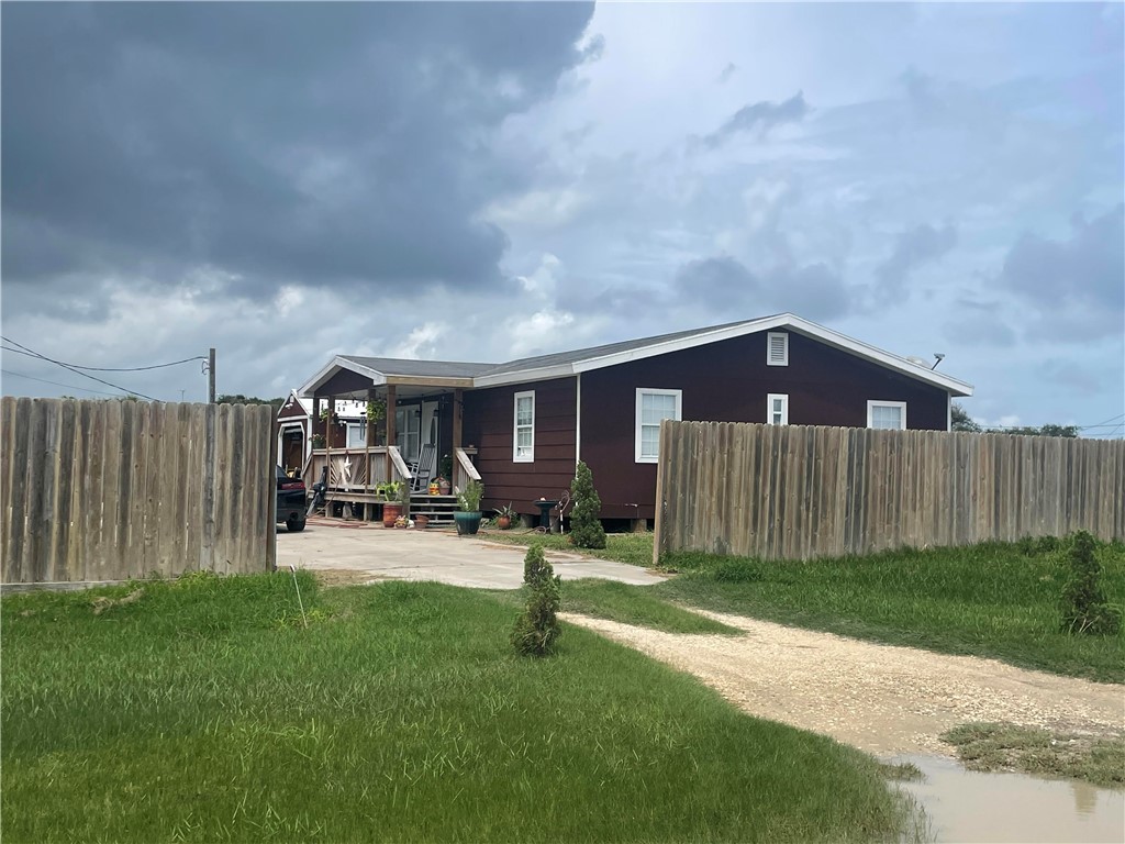 a view of a house with backyard porch and sitting area