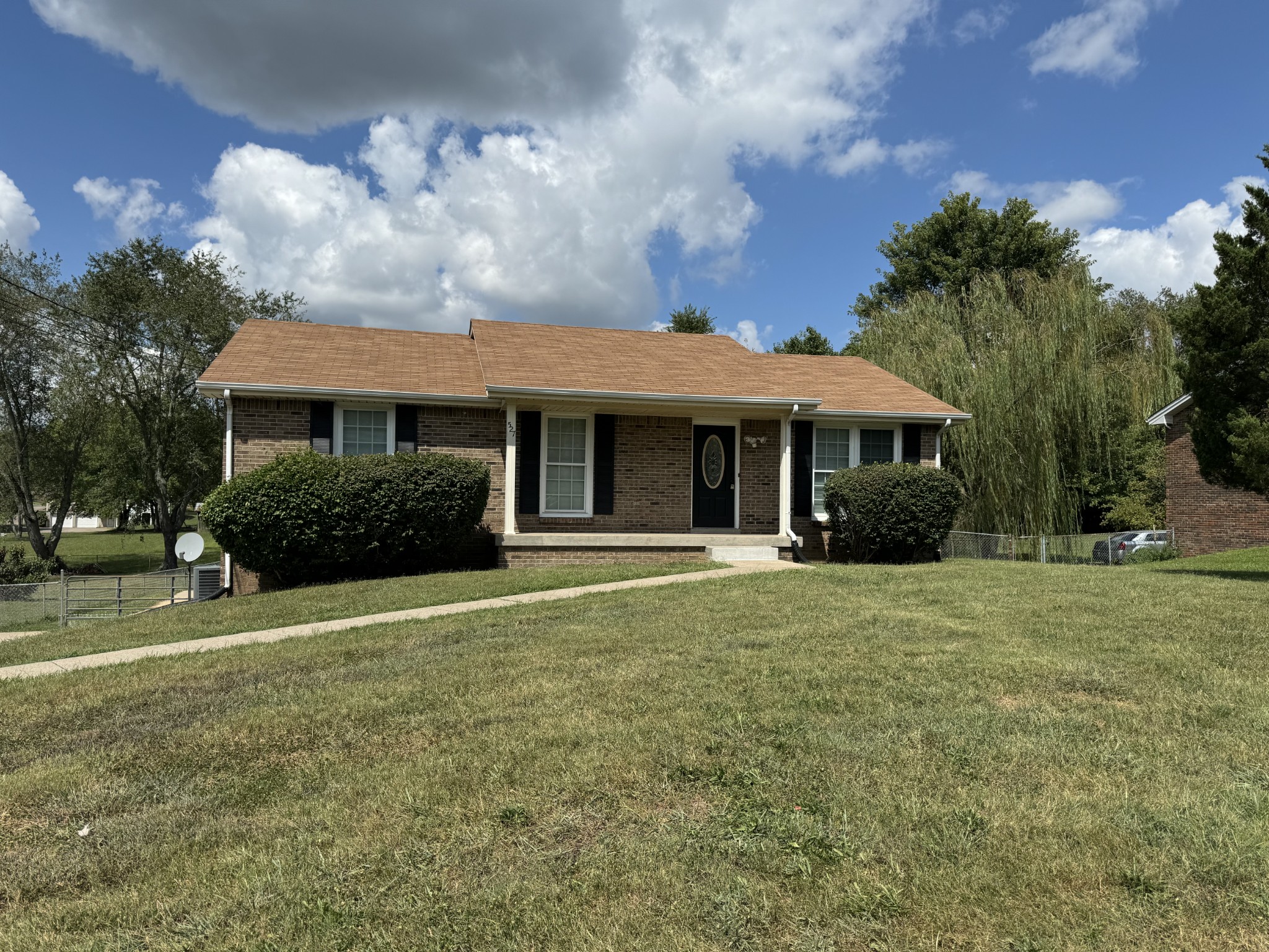 a front view of a house with a garden