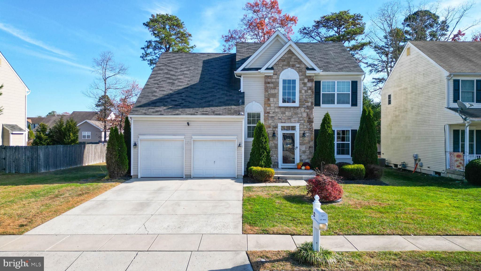 a front view of house with yard and green space