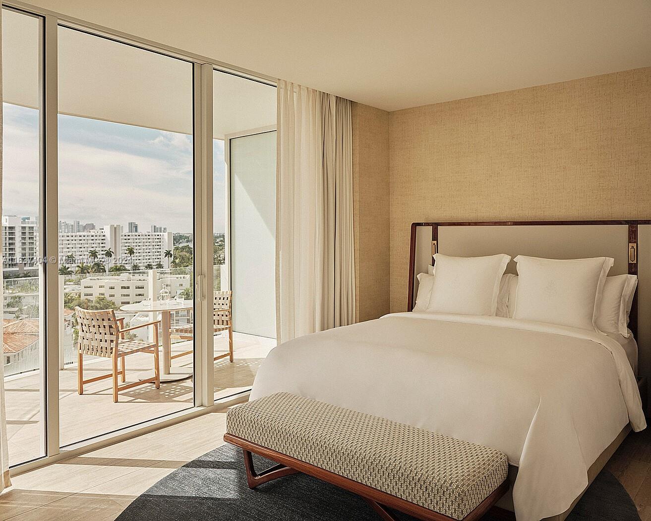 a large bed sitting in a bedroom next to a window