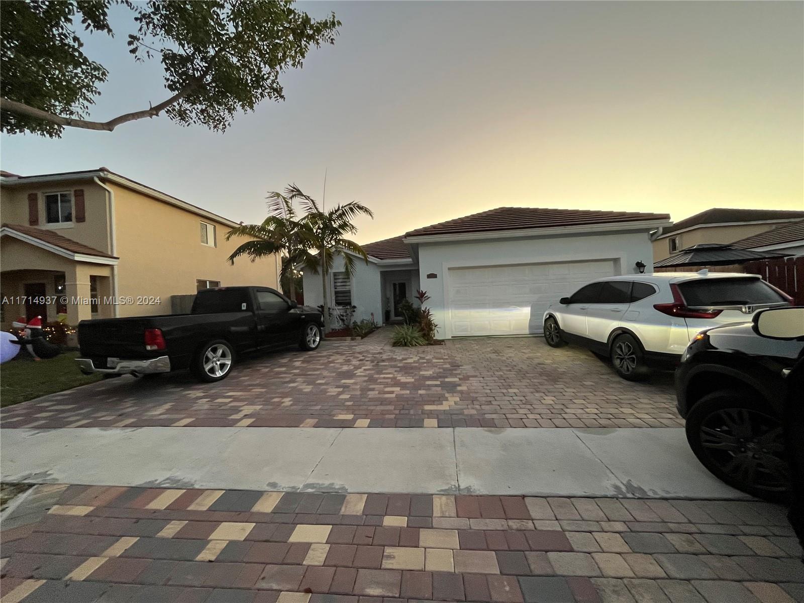 a couple of cars parked in front of a house