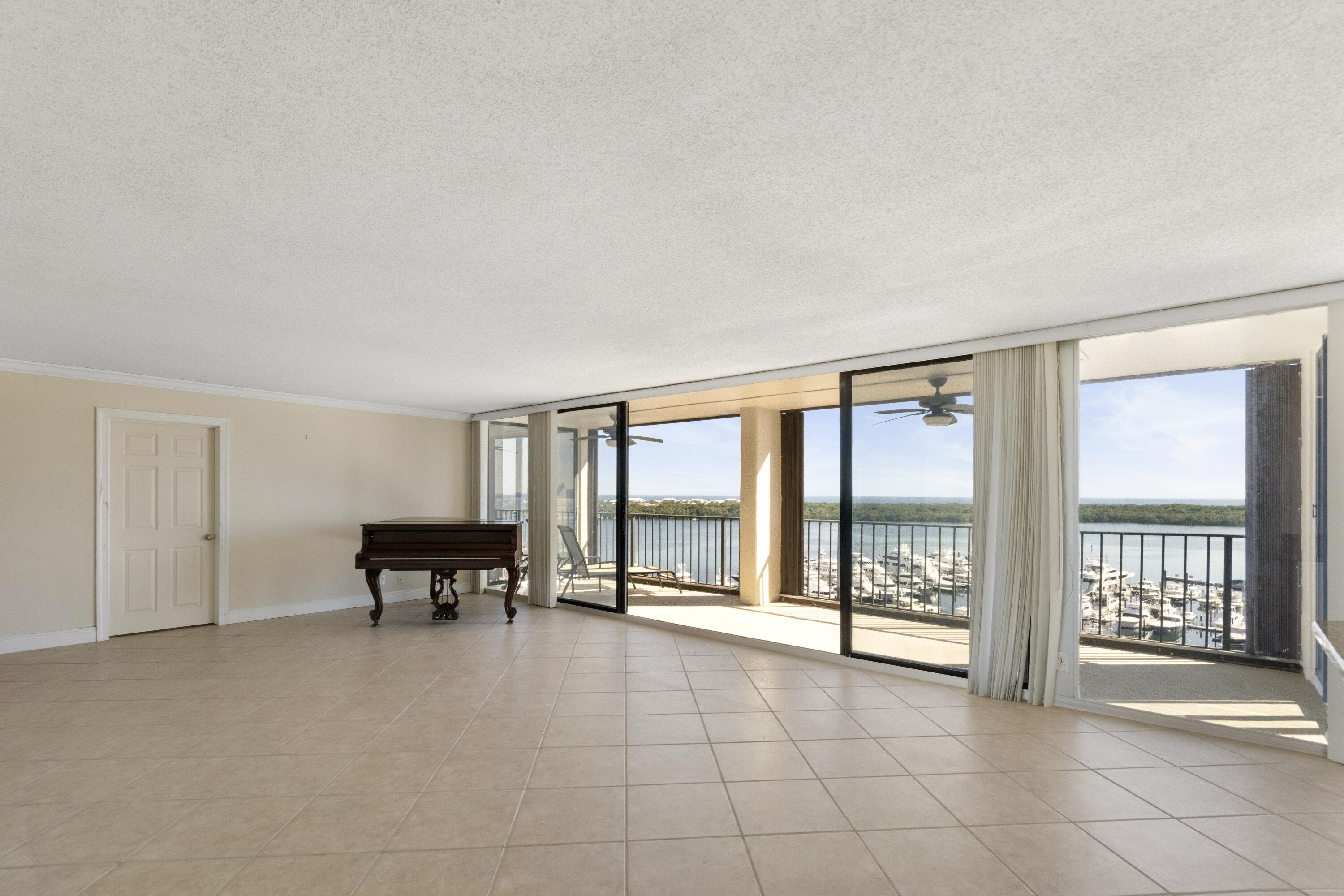 a view of an empty room with wooden floor and a fireplace