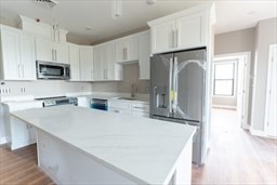 a kitchen with counter top space cabinets and stainless steel appliances