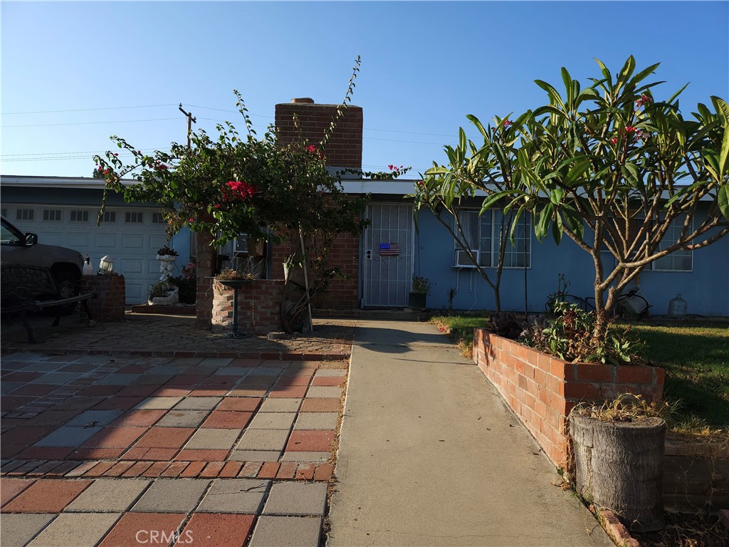 a house with flower garden in front of it