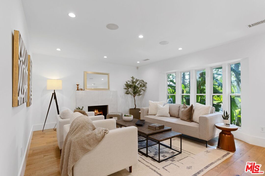 a living room with furniture a fireplace and a table