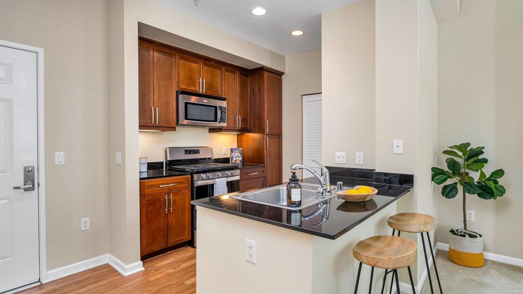 a kitchen with a sink appliances and cabinets