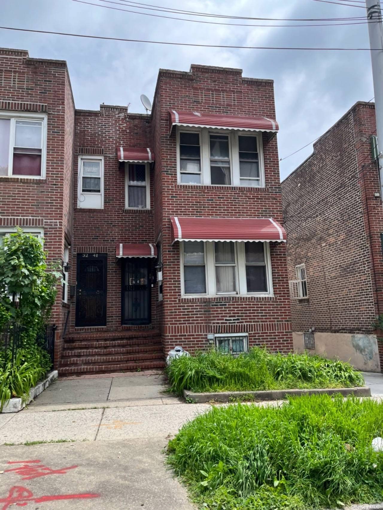 a brick building with a yard in front of it